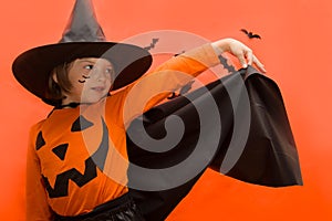 Halloween. Girl dressed as a witch with a pumpkin