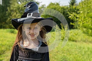 Halloween girl going to collect candy. Trick-or-treating. Guising. Jack-o-lantern. Child in carnival costume witch