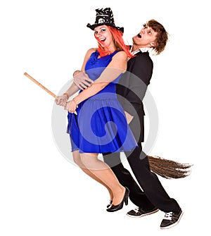 Halloween girl witch on broom with man.