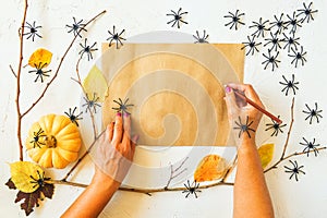 Halloween grunge white background, woman hand with pencil