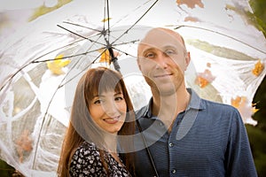 Halloween. Happy couple at Halloween picnic. Emotion concept. Man and woman under an umbrella with cobwebs