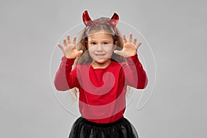 Girl costume with devil`s horns on halloween