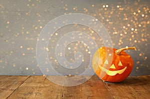 Halloween holiday concept. Cute pumpkin on wooden table