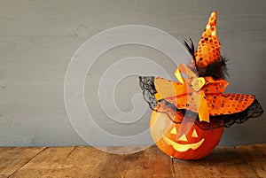 Halloween holiday concept. Cute pumpkin on wooden table