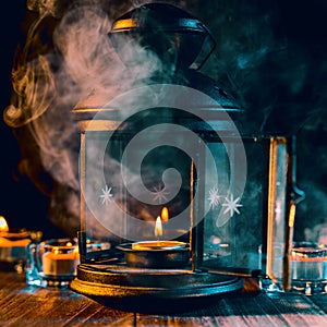 Halloween holiday concept design of pumpkin, candle, spooky decorations with green tone smoke around on a dark wooden table, close