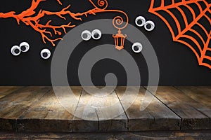 Halloween holiday concept. Empty rustic table in front of haunted forest with eyes staring out of the darkness. Ready for product