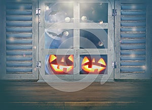Halloween holiday concept. Empty rustic table in front of haunted night sky background and old window. Ready for product display m