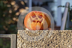 Halloween holiday pumpkins on the fence, carved funny and scary faces. Halloween, All Saints\' Day in Europe.