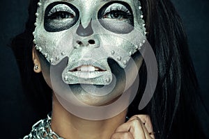 Beautiful girl model with black body with silver mask