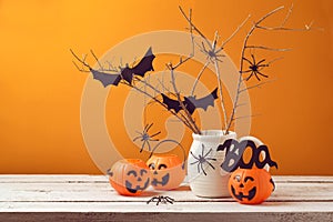 Halloween home decorations with spiders and pumpkin bucket photo