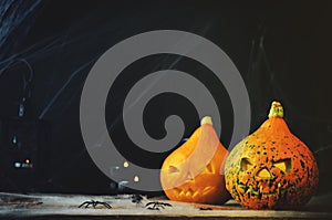 Halloween horror background with a spider`s web, pumpkins, candl