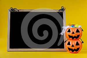 Halloween Jack o Lantern bucket and blank chalkboard on yellow b