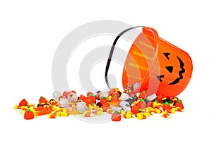 Halloween Jack o Lantern candy collector with spilling candy over white