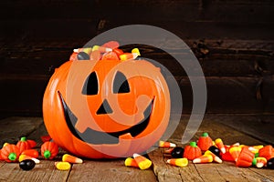 Halloween Jack o Lantern candy holder on wood background