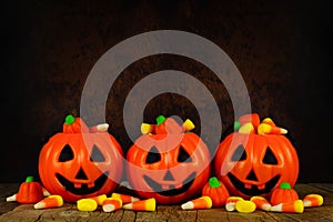 Halloween Jack-o-Lantern candy holders with orange and black background photo