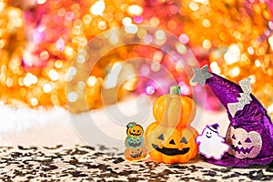 Halloween jack o lantern pumpkin and witches hat with smiling ghost  on  a shiny colorful background.