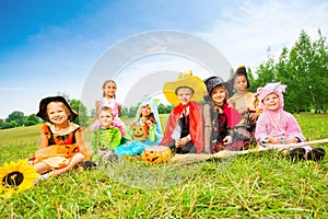 Halloween with kids in costumes sit outside