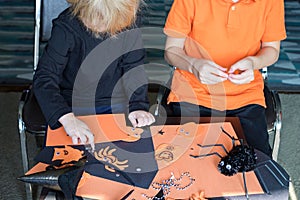 Halloween kids craft preparations. Little children doing crafts at home or school