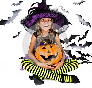 Halloween kids, Happy scary girl dressed up in halloween costume of witch, sorcerer for pumpkin patch and halloween party