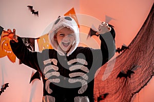 Halloween kids Portrait boy in Halloween skeleton costume at home. Boy is Ready for the trick or treat holiday