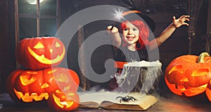 Halloween. little witch child cooking potion with pumpkin and
