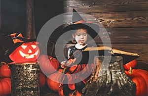 Halloween. little witch conjures with book of spells, magic