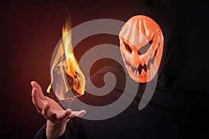 Halloween man with pumpkin mask control fireball