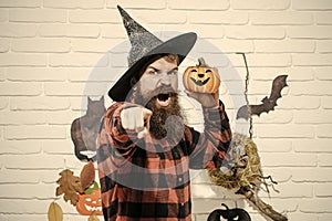 Halloween man with pumpkin in witch hat