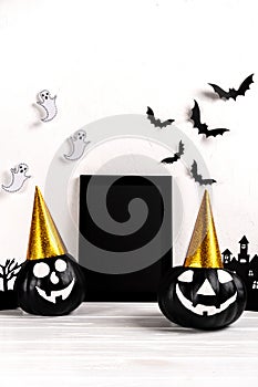 Halloween mock up. Black photo frame and paper art abandoned village , pumpkin on white background