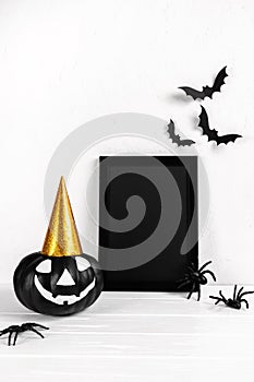 Halloween mock up. Black photo frame and paper art  pumpkin on white background