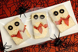 Halloween monster sandwiches with spiderweb background