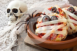 Halloween mummies mini pizzas on wood