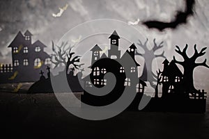 Halloween night background. Paper art. Abandoned village in a dark misty  forest
