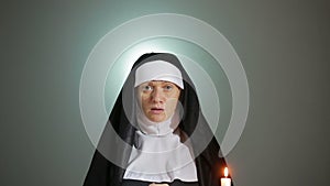 Halloween. nun prays. shadows in the form of devil. exorcism