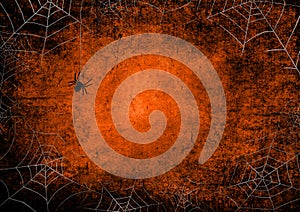 Halloween orange and black grunge background with silhouettes of spiders and webs