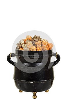 Halloween orange and black licorice popcorn in old black cauldron