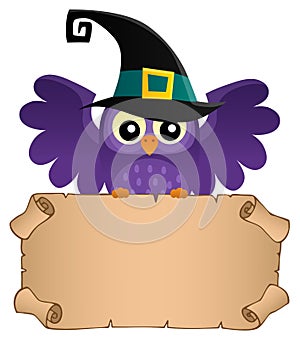 Halloween owl holding small parchment