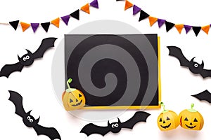 Halloween paper bats and pumpkins on white background