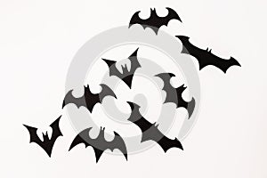 Halloween paper black bats on white background. Flat lay, top view.