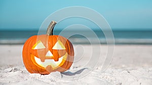 Halloween party on the beach. Pumpkin Jack-o`-lantern. Jack o lantern for Happy Halloween. Autumn season. On background ocean. Aut