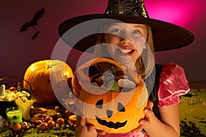 Halloween party with a child showing candy