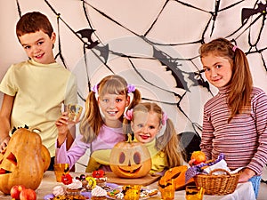 Halloween party with children eating trick or treat food.