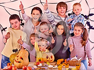 Halloween party with children holding trick or