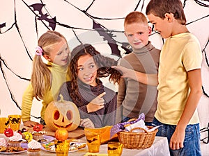 Halloween party with children holding trick or