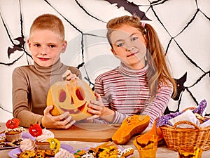 Halloween party with children holding trick or