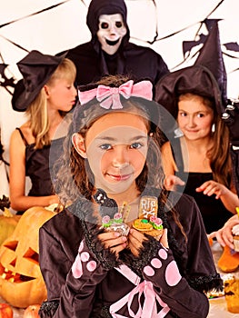 Halloween party with children holding trick or