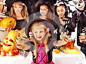 Halloween party with children holding trick or treat.