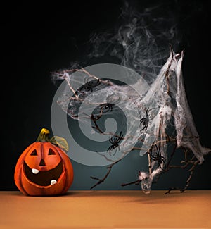 Halloween party concept with Funny Pumpkin, spider and spider web, on a dark background.