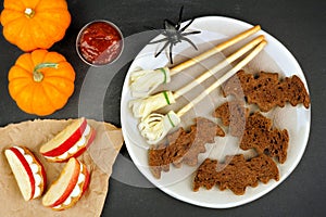 Halloween party food with bat breads, broomsticks and apple teeth