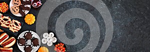 Halloween party food corner border over a black stone banner background with copy space